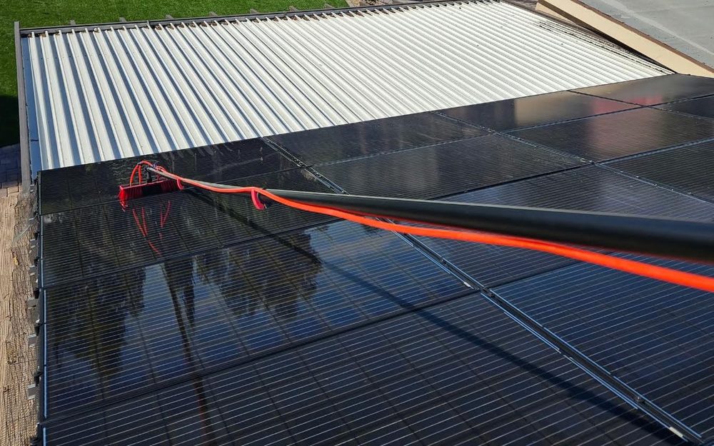 Robles Property Care cleaning solar panels with a water-fed brush in Las Vegas